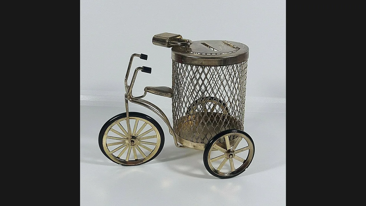 A brass bicycle-shaped coin bank with a coin slot